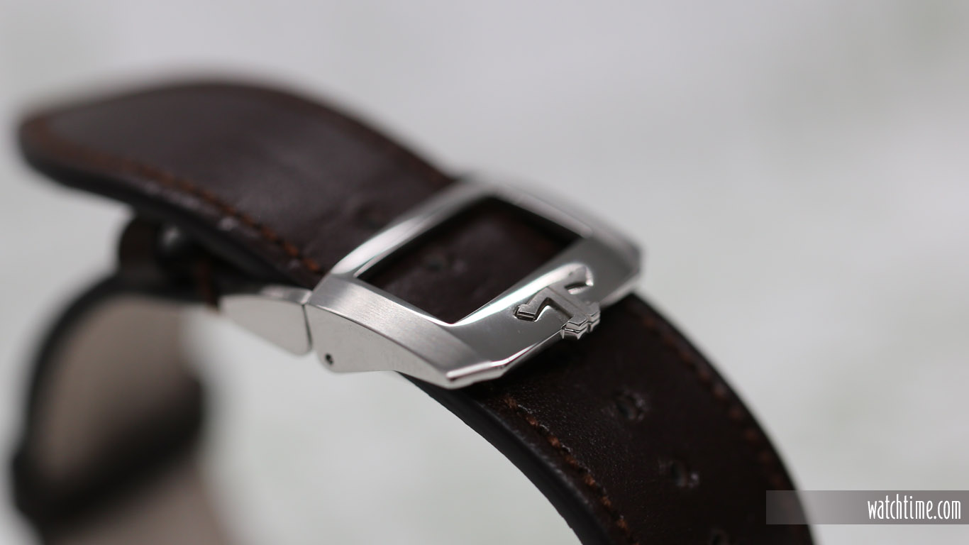 The brown calf leather strap has a faux patina.