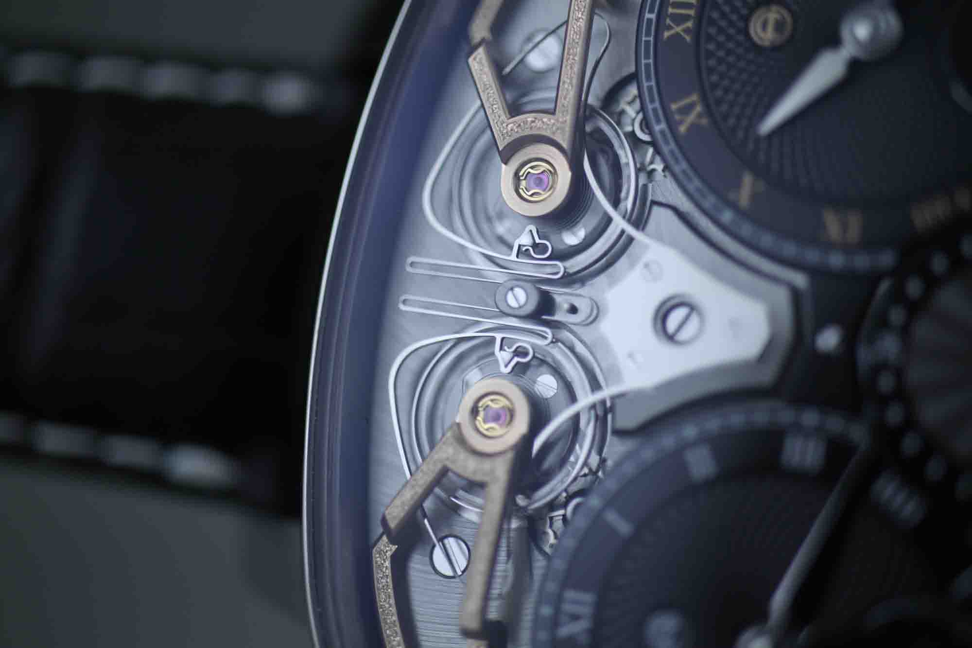 The coupling spring that enables the resonance.