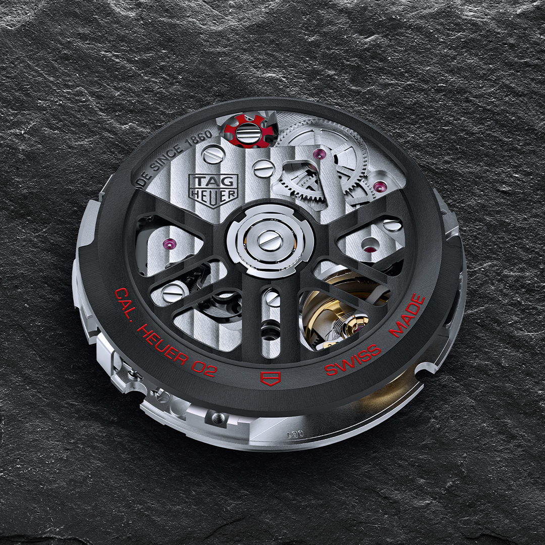 The Calibre Heuer 02 is an eye-catcher with its red column wheel, black rotor and decorative cutouts.