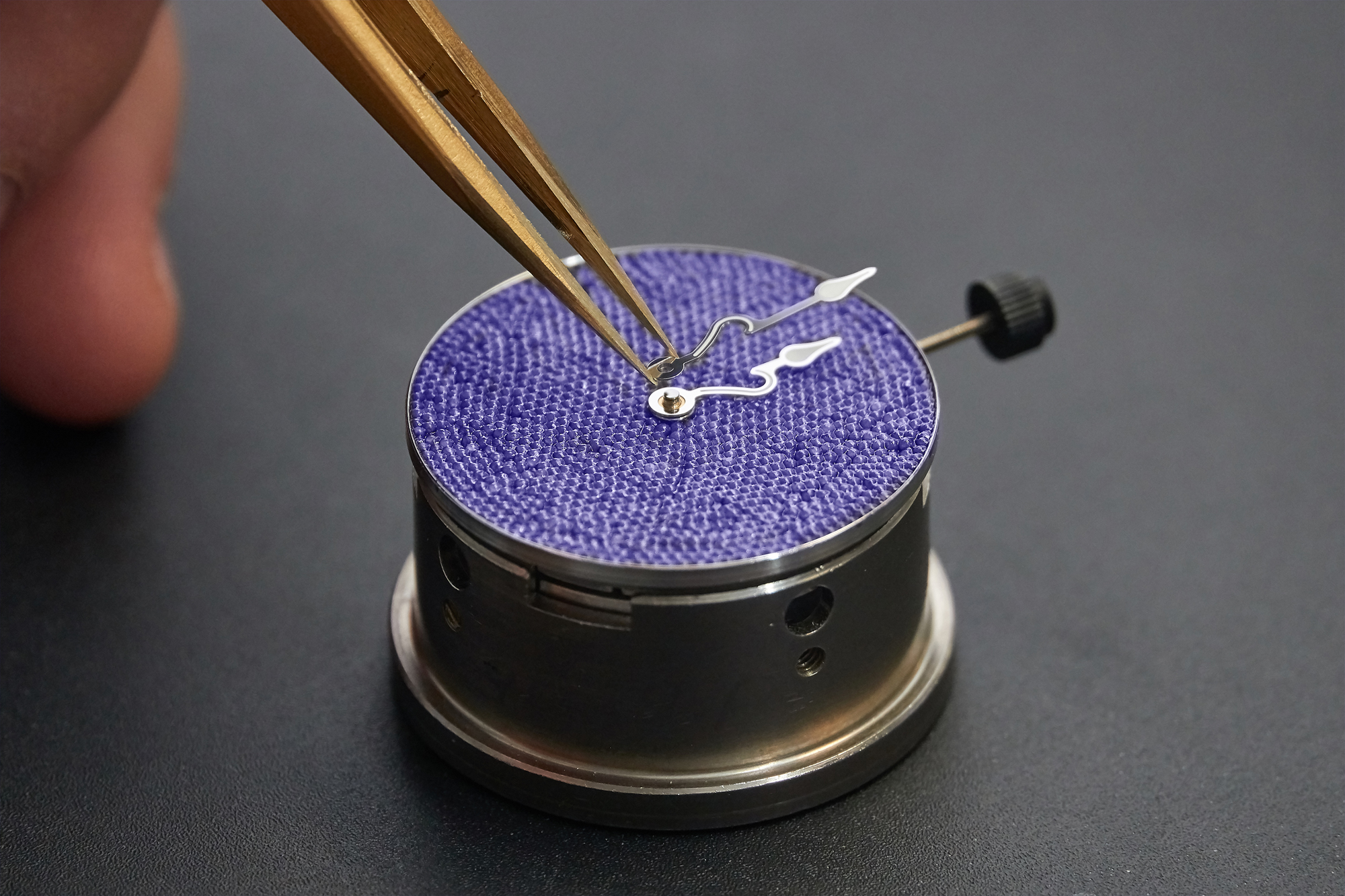 The placement of the specially crafted hands is the last part of the dial-making process.