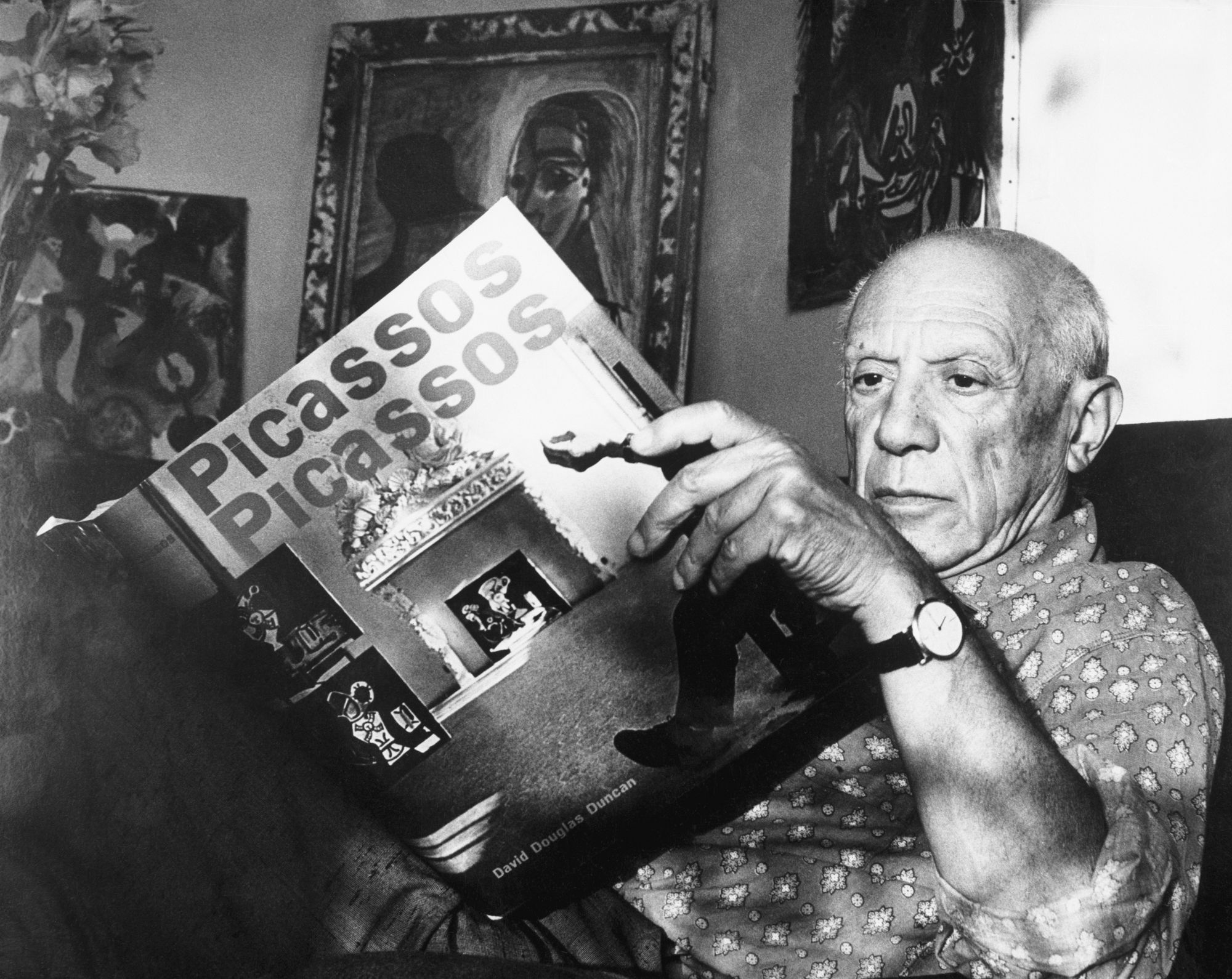 Pablo Picasso reading a book, via Getty Images.jpg