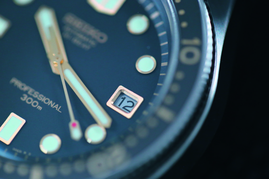 Close-up of the matte black dial with contrasting gold indexes.