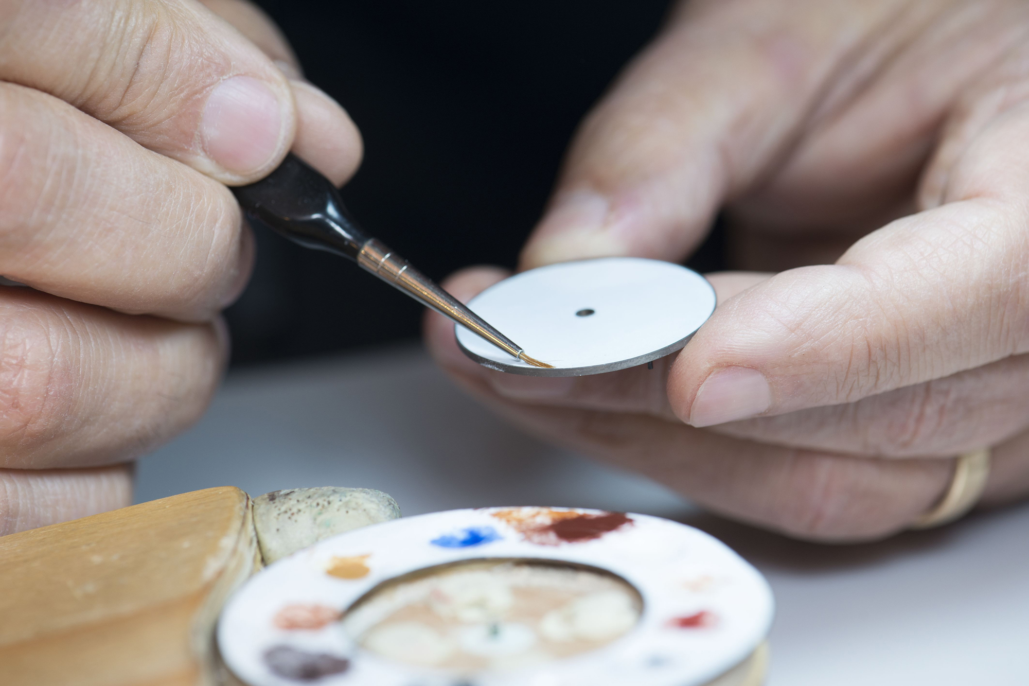 Applying the first color base to the dial. 