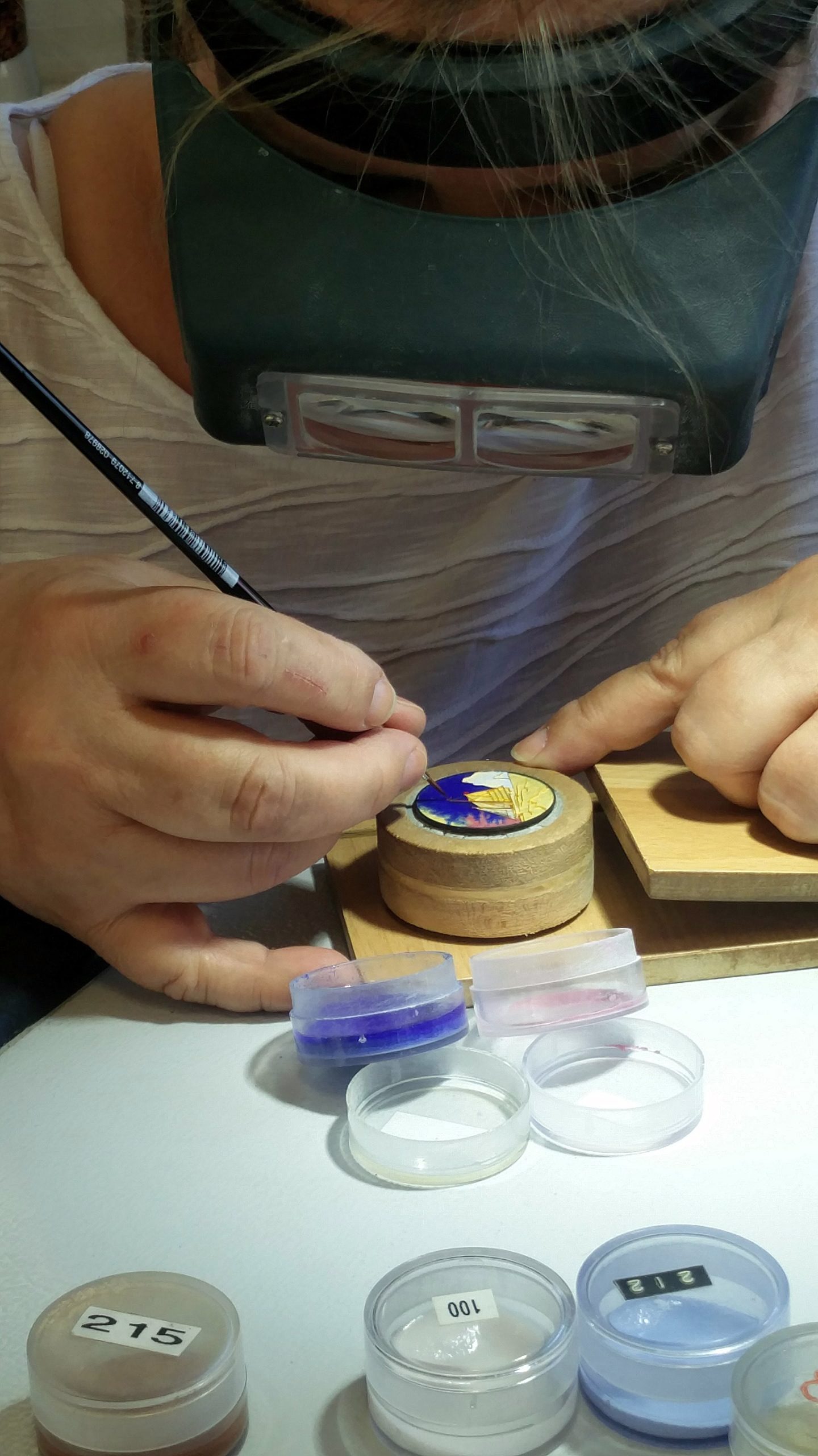 Adding color to the details on the dial with the enamel powder paint. 
