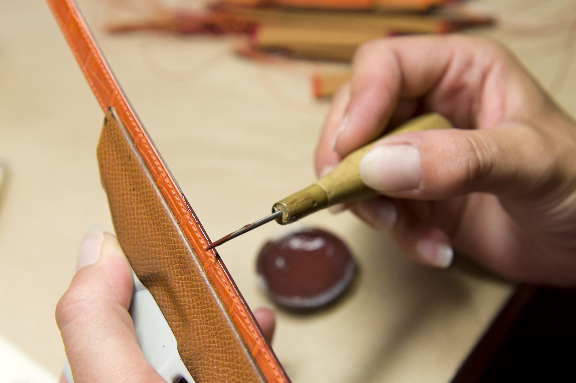 The next step, processing the edges, usually requires at least 15 separate tasks. Each is executed by hand: abrading, waxing in the desired color, heating to between 176 and 212 degrees Fahrenheit, and polishing. Depending on the strap, the entire procedure must be repeated as often as five times. Afterward, slim grooves are embossed into the upper leather parallel to the strap’s margins. Finally, the atelier’s director scrutinizes each strap under a loupe. If he discovers no flaws, the strap is punched with marks specifying its material and year of manufacture. The letter “K,” for instance, denotes bands made in 2007. An “L” means the strap was made at La Montre Hermès in Bienne and a “V” means it was made in Paris.