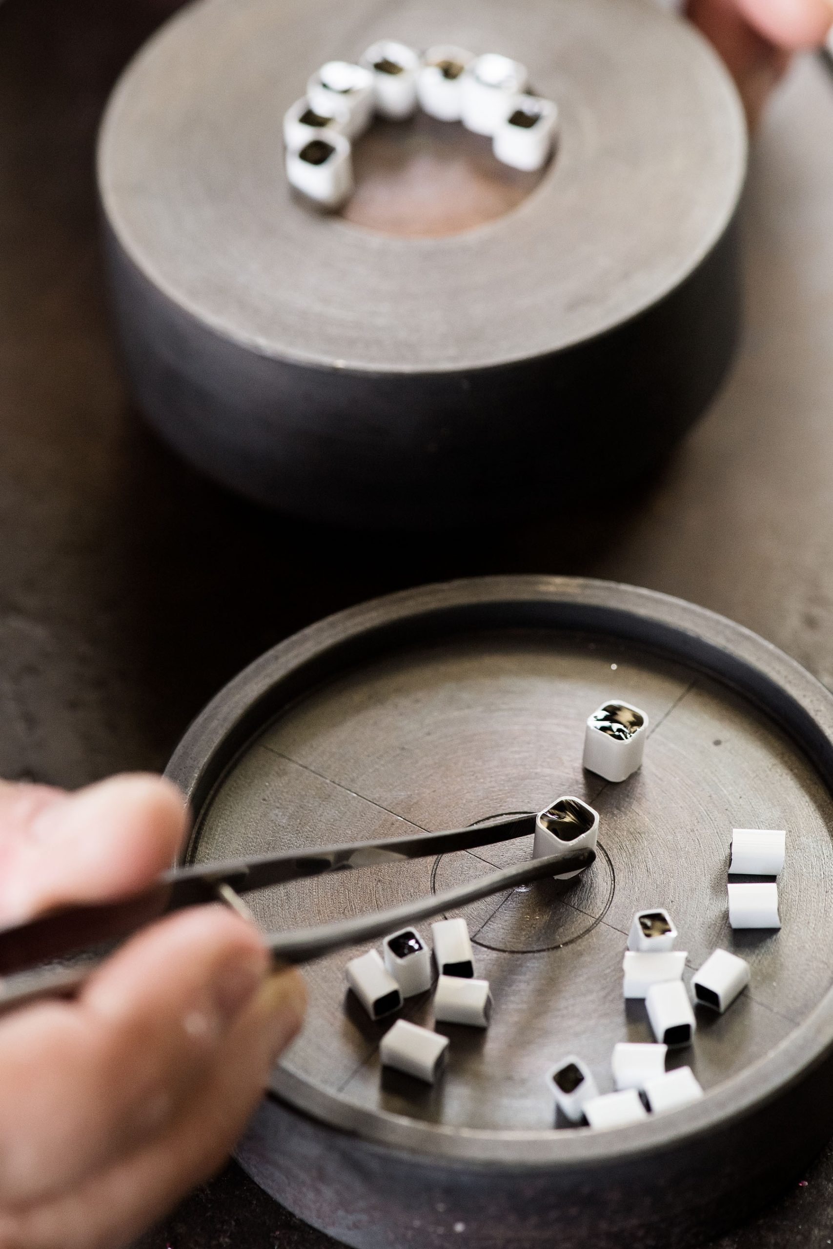 Making the Millefiori using patterns assembled from hot threads pulled from the molten material drawn from the mouth of the pots in the furnace. 