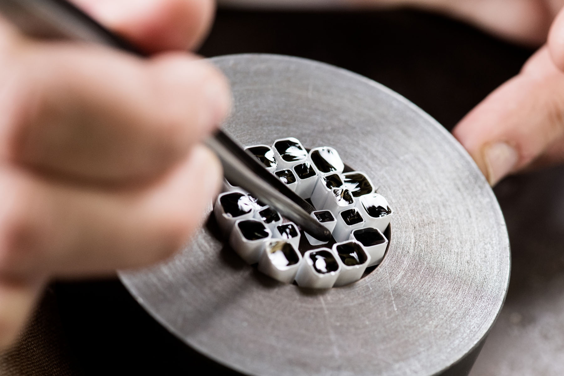 Making the Millefiori using patterns assembled from hot threads pulled from the molten material drawn from the mouth of the pots in the furnace. 