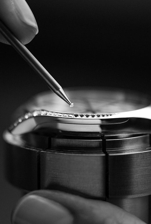 Second, the watchmaker uses a small setter's tool to delicately place each stone in position before pressing them down. 