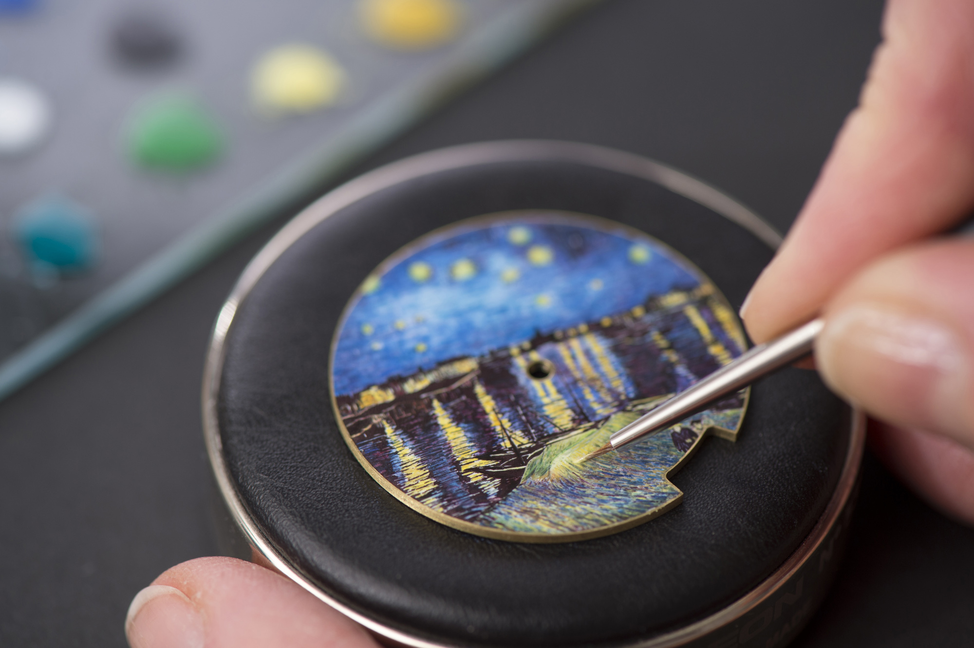 The artisans work with a gold case featuring a 0.4 mm recess coated with three layers of white enamel. The motif is then designed using enamel fragments coloured by metal oxides that are crushed to powder and mixed with oil.