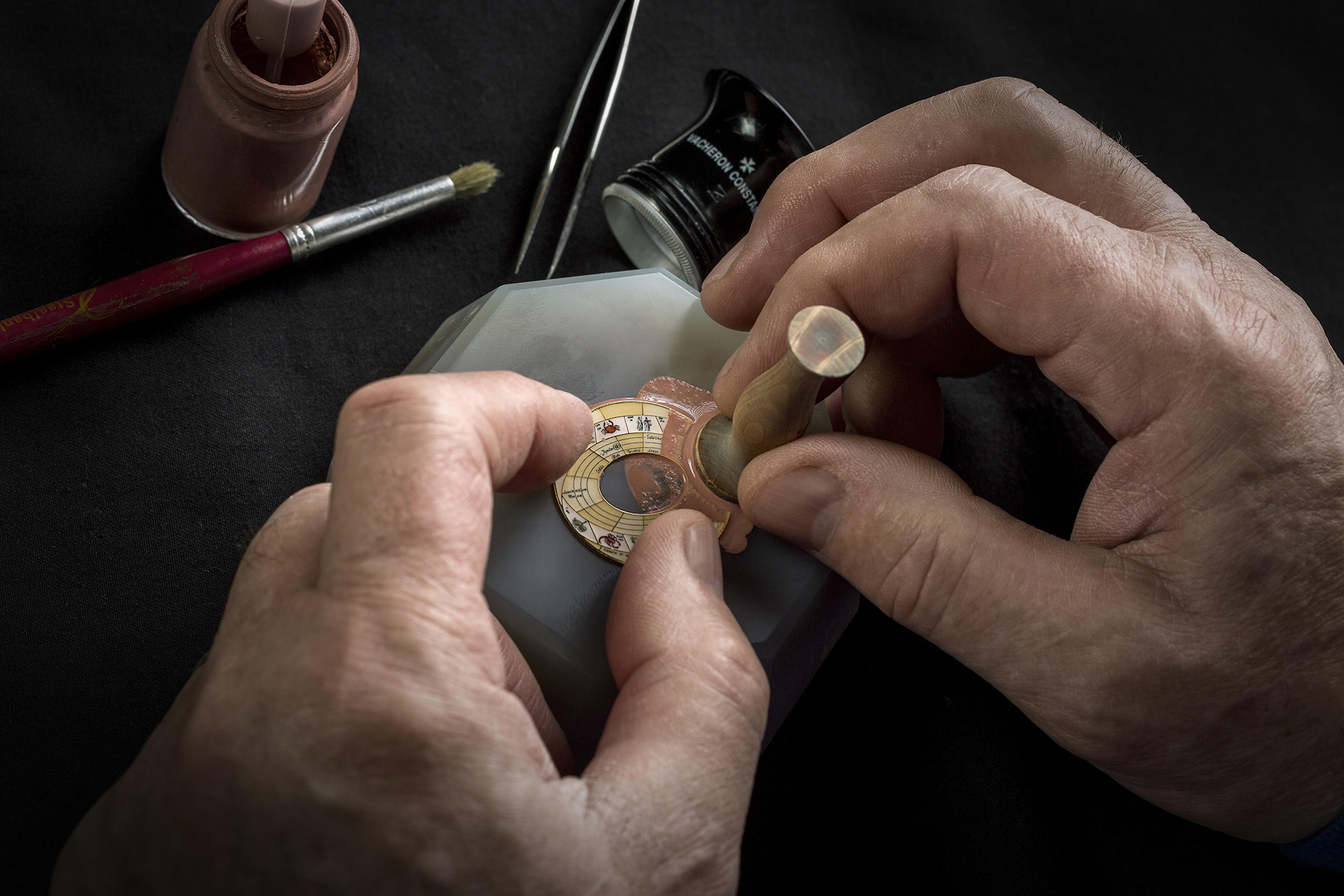 This dial is then smoothed with an abrasive stone, lapped, and polished.