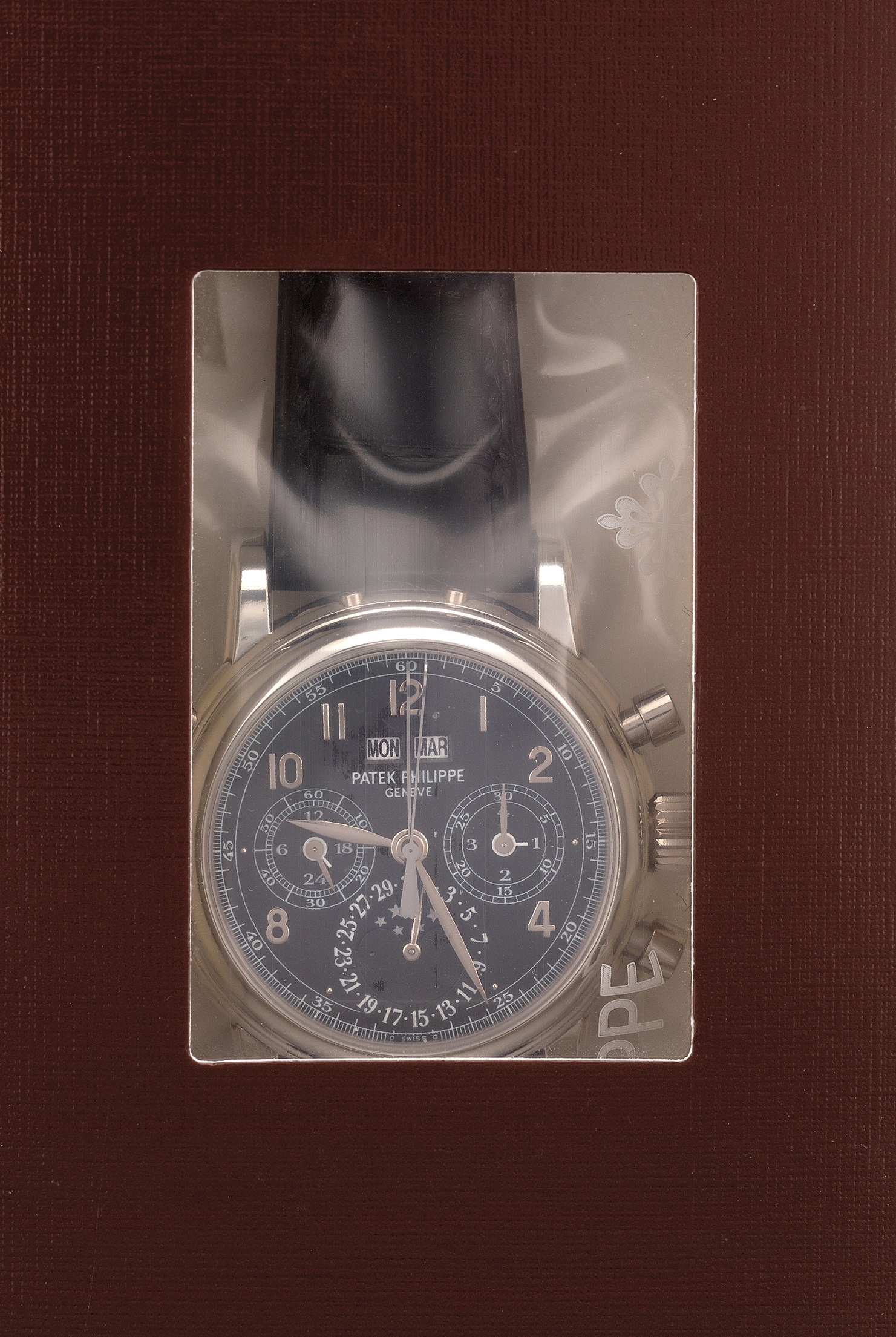 A platinum perpetual calendar split-seconds chronograph wristwatch with moon phases, leap year indicator, special black dial, and original certificate. Sold for $287,392