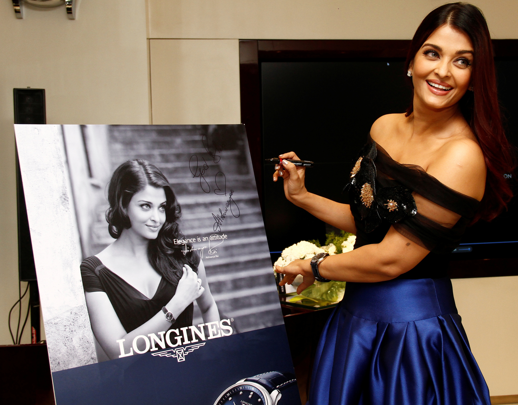 Longines Ambassador of Elegance, Aishwarya Rai Bachchan signs the easel during the inauguration of the new Longines boutique at U.B. City, Bengaluru amongst media and key customers.