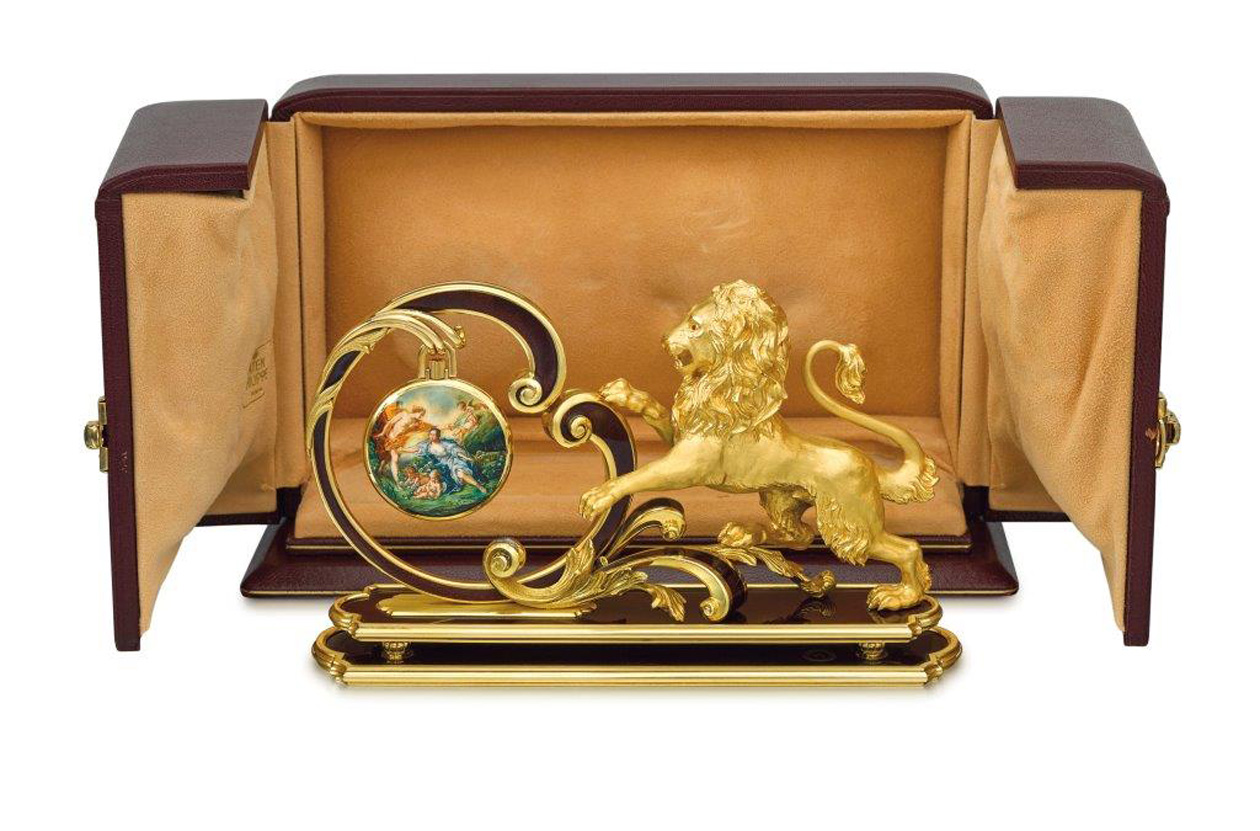 Hailing from the property of the late Claude Nobs, founder of the famous Montreux Jazz Festival, this  Patek Philippe enamel watch entitled “Apollon et Issé” is decorated with a unique enamel painting after François Boucher created by master enamellist G. Menni in 1985, who worked for Patek Philippe on several commissioned pieces throughout the 80s. Accompanying the watch is a unique gold and enamel Patek Philippe watch stand named “Le Lion” with an impressive gold weight of over 1 kilo. This ensemble was part of the interior of Nobs’ mystique chalet “Le Picotin” and admired by countless musicians and artists he entertained over decades
