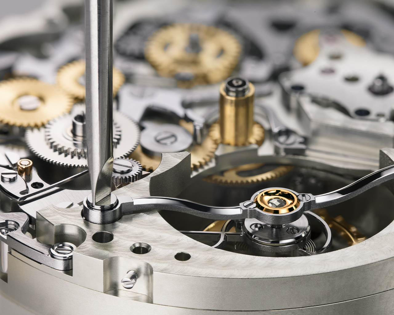 The tourbillon bridge firmly secures the cage to the chronograph bridge as it rotates suspended between two diamond endstones.