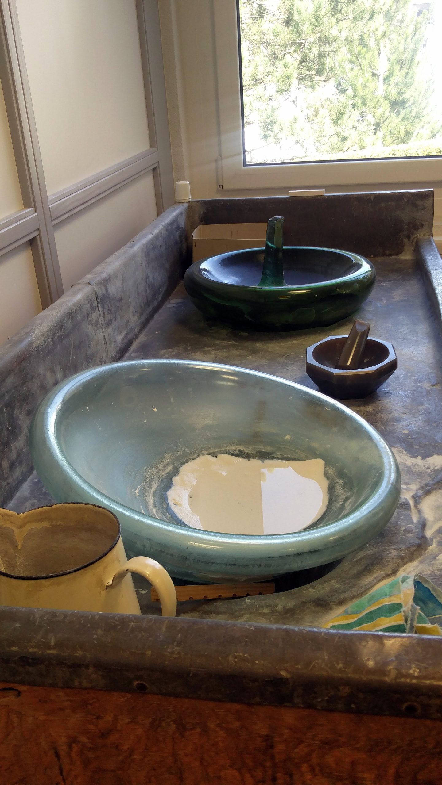 The pure enamel powder is separated from any other substances that may be in the powder, by mixing water, and rocking the bowl back and forth. The pure powder is left behind at the end. 