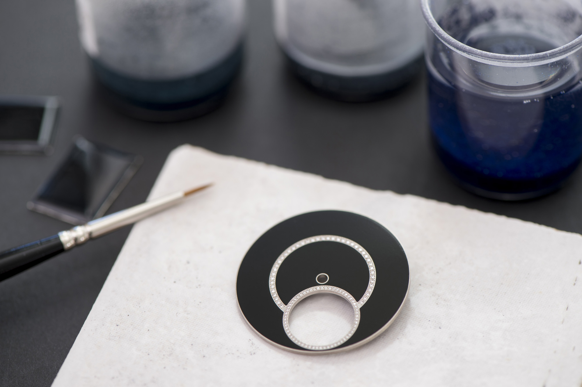Six to ten layers of transparent protective enamel are then applied to the dial that is carefully sanded and polished to achieve a shiny, finely glazed appearance.
