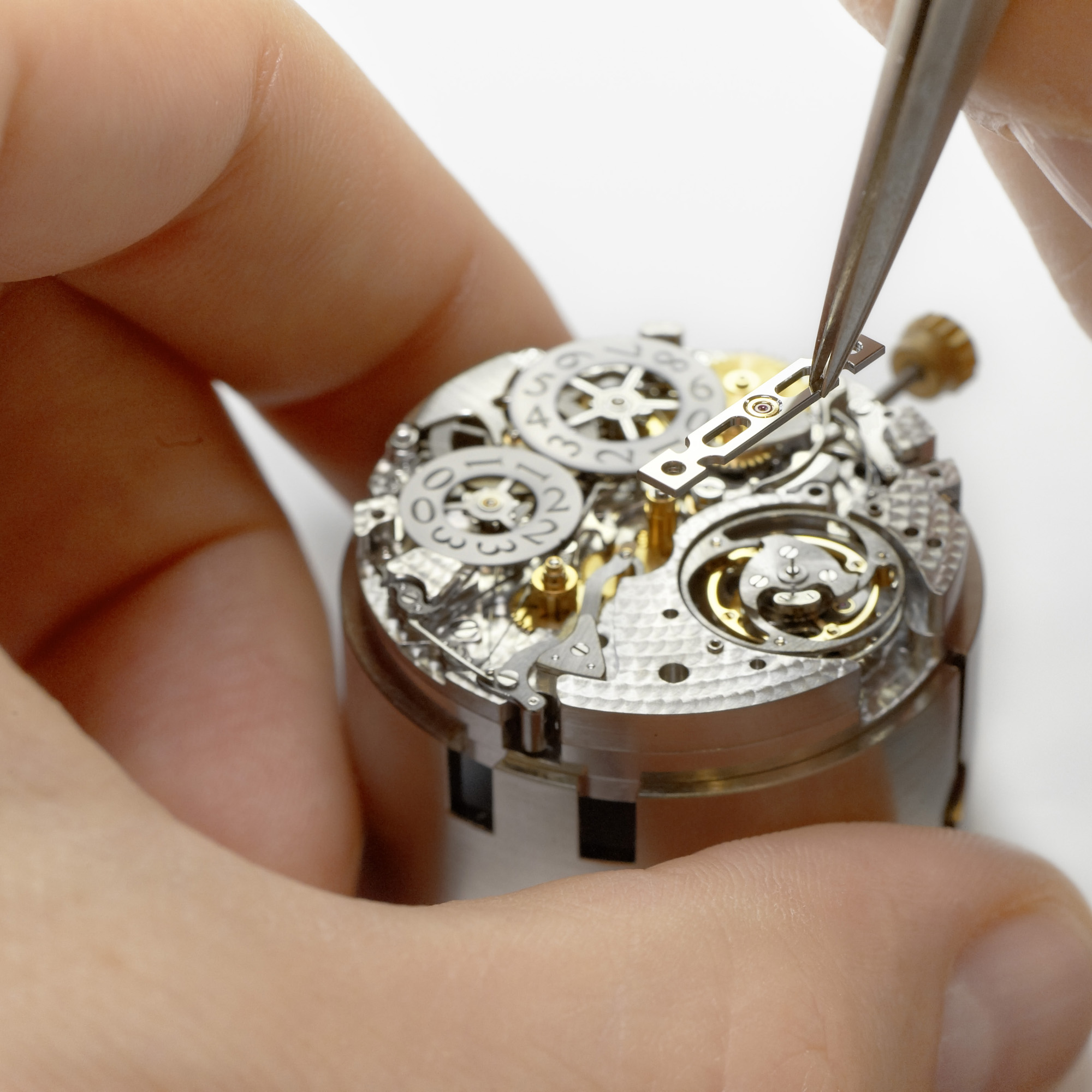 The master watchmaker places the tourbillon’s lower bridge